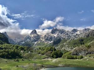 a view of a mountain range with a body of water at Vikendica Ivanović in Prisoja