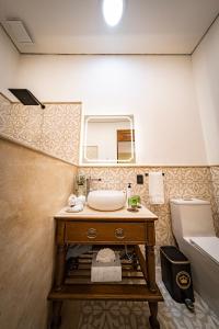 a bathroom with a sink and a toilet and a mirror at Hotel Emperador Orizaba in Orizaba +39 photos