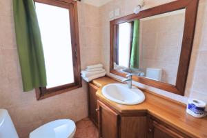 a bathroom with a sink and a mirror and a toilet at Watamu Ascot Residence in Watamu