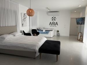 a bedroom with a bed and a table and chairs at אריאה צימר בוטיק לזוגות Aria in HaZore‘im