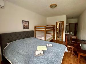 a bedroom with a bed and a desk and a mirror at Apartment Lotika in Višegrad