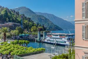 a view of a river with two boats docked at Appartamento Splendore in Bellagio