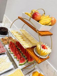 a shelf of cheese and fruit on a table at Vértice Hotel in Brasília +33 photos