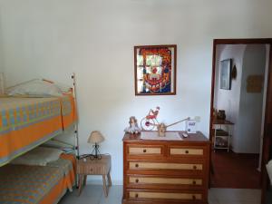 a bedroom with two beds and a dresser and a mirror at Casa Algiana - Private Pool in Loulé +34 photos