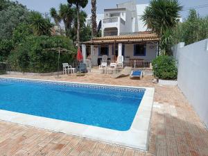 a swimming pool in front of a house at Casa Algiana - Private Pool in Loulé