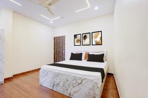 a white bedroom with a bed in a room at Hotel O Swarg Paradise Inn in Rānchī