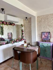 a dining room with a table and some flowers at Nibelungos House - Alojamiento artesanal Whimsical frente al Pantano de San Juan - 3 min a pie in San Martín de Valdeiglesias