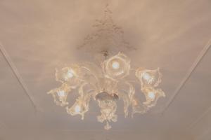 a chandelier hanging from a ceiling in a room at Appartamento The Rich Man in Bellagio +58 photos