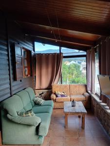 a living room with a couch and a table at Casa Carballar in Oia