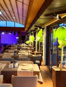 a restaurant with white tables and chairs and purple lighting at Dreamland Aparts in Chakvi +62 photos