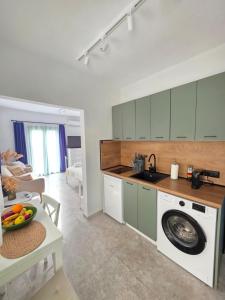 a kitchen with a washing machine in a room at Sun & Moon Studio Afitos in Afitos