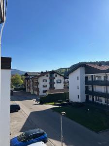 a parking lot with a car parked in front of a building at Staufen Stern in Oberstaufen
