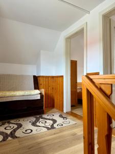 a room with a bed and a rug on the floor at Casuta-Maria-Kisház in Sovata