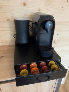 a coffee maker sitting on top of a table with donuts at Staufen Stern in Oberstaufen