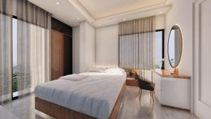 a bedroom with a bed and a desk and a mirror at Hotel Adi International in Rājshāhi