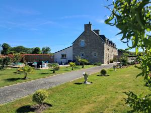 an old stone building with a road in front of it at gîte en campagne Lamégritnière in Mégrit