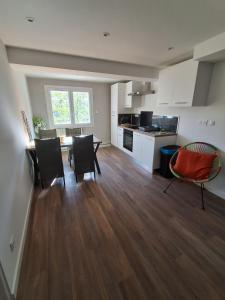 a kitchen and dining room with a table and chairs at The Cévennes break in Anduze