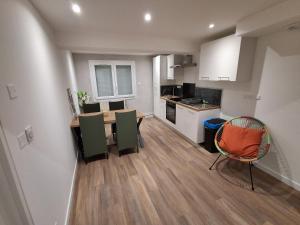 a kitchen and dining room with a table and chairs at The Cévennes break in Anduze