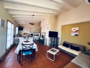 a living room with a table and a couch at I Love Perpignan Duplex Terrasse in Perpignan