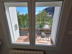 a window in a room with a view of a balcony at The Cévennes break in Anduze +6 photos