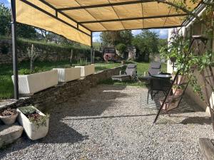a patio with a table and chairs under a tent at La Guitoune in Mane