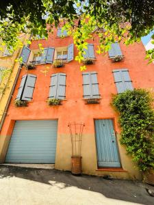 an orange building with two garage doors and windows at I Love Perpignan Duplex Terrasse in Perpignan