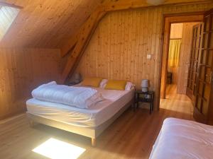 a bedroom with two beds in a attic at Le chalet de Pierrot in La Malène