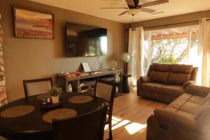 a living room with a table and a couch at Dumplin Patch Bed & Breakfast in Williams