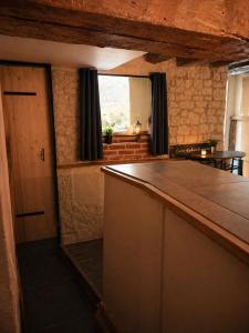 a kitchen with a large counter and a window at Suite spa Romantique avec piscine privée cosy clim in Coligny
