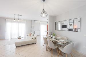 a white living room with a table and chairs at Electras house in Kassandra