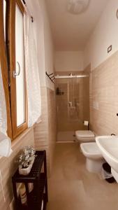 a bathroom with a toilet and a sink and a shower at Il Campanile 2 in Fondi