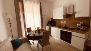 a kitchen and a living room with a table and a couch at Il Campanile 2 in Fondi +21 photos