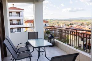 a balcony with a table and chairs and a view at Electras house in Kassandra