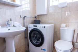 a bathroom with a washing machine and a sink at Electras house in Kassandra +36 photos