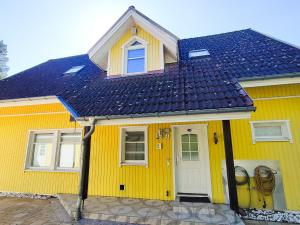 a yellow house with a blue roof at GlanzExperts Auszeit bei Berlin Balkon Kicker & DisneyPlus in Zossen