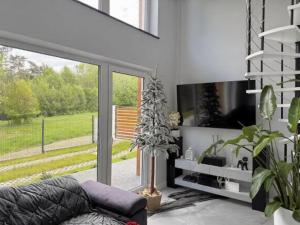 a living room with a couch and a large window at KLIMKOWSKA osada in Klimkówka