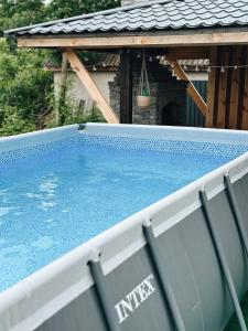 a swimming pool in front of a house at Зелена долина in Solgutovo