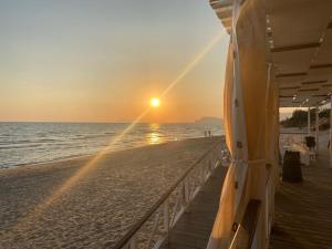 a pier on the beach at sunset at Il Campanile 2 in Fondi