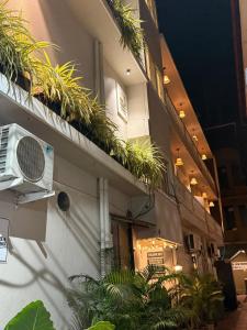 a building with plants on the side of it at RJ14 Accommodations at Baga Beach in Baga