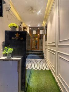 a hallway with a door and a green floor at RJ14 Accommodations at Baga Beach in Baga