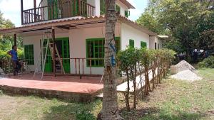 a man standing in front of a house at Apartaestudio la Ísla in Estación El Salto