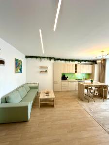 a living room with a couch and a table at Marconi Premium Apartments in Mamaia
