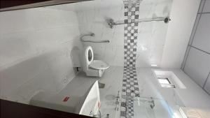 a bathroom with a tub and a toilet and a sink at Hotel Araamish in Peshawar +14 photos