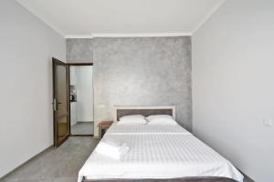 a bedroom with a white bed and a mirror at free shuttle in Zvartnots International Airport