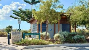 a small building with a street sign in front of it at Galley Cove House in Geographe