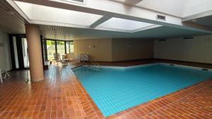 a large swimming pool with a tile floor at Seegarten Apartment 4 in Hagnau