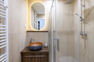 a bathroom with a bowl sink and a shower at Budapest Holidays Storia in Budapest +39 photos