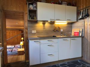 a kitchen with white cabinets and a sink at Großes Ferienhaus fuer 8 Personen, Manderscheid in Manderscheid