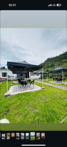 a group of picnic tables and umbrellas in a park at Snong-Gree Motel and Restaurant in Rupa