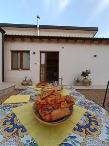 a table with a plate of food on it at Borghetto Meti in Avola